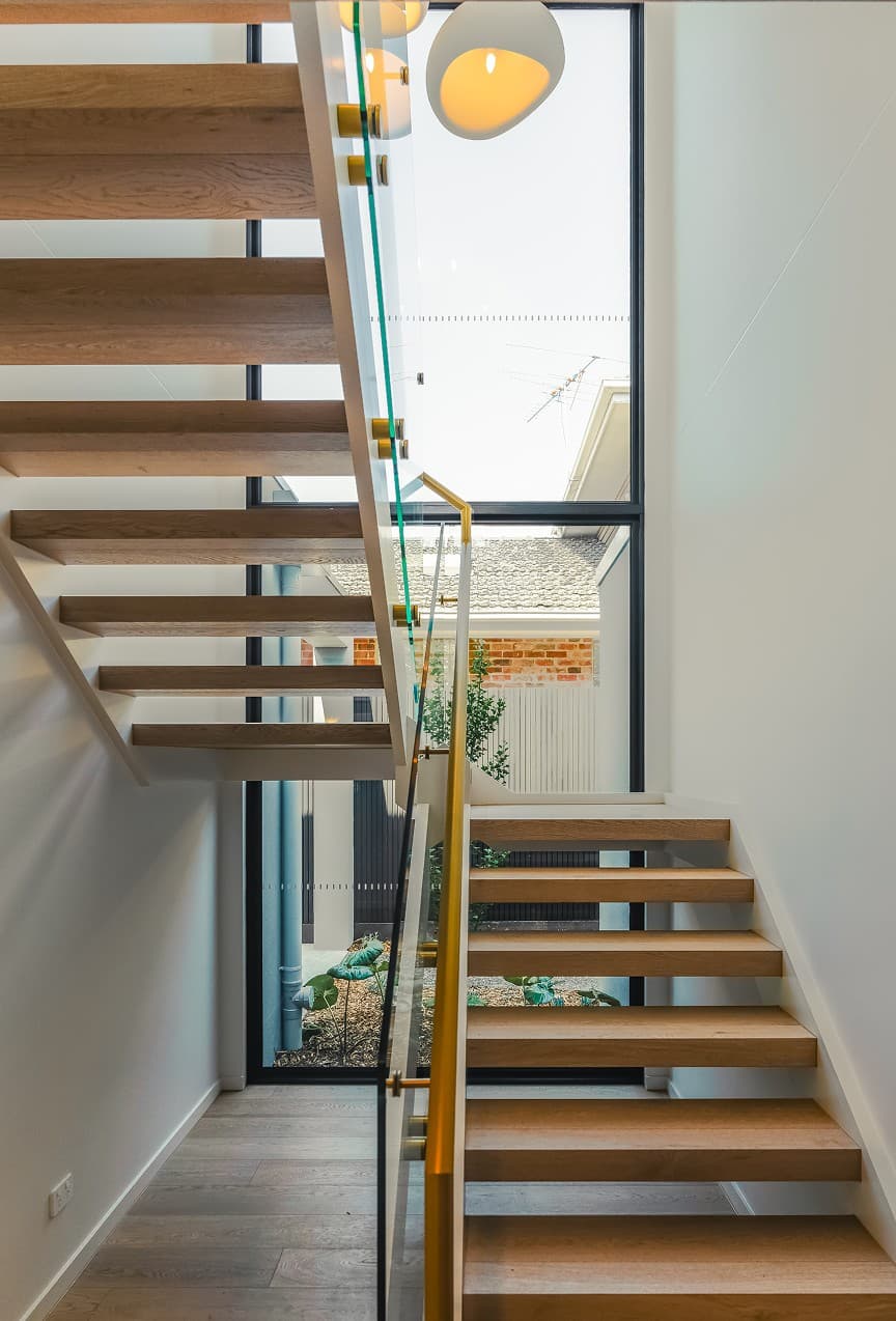 Staircase with glass balustrade and full-height glazing