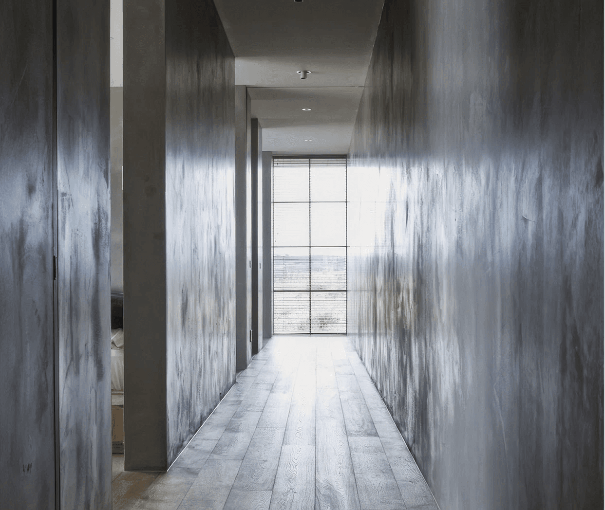 Vue project — concrete corridor to a slim full-height window